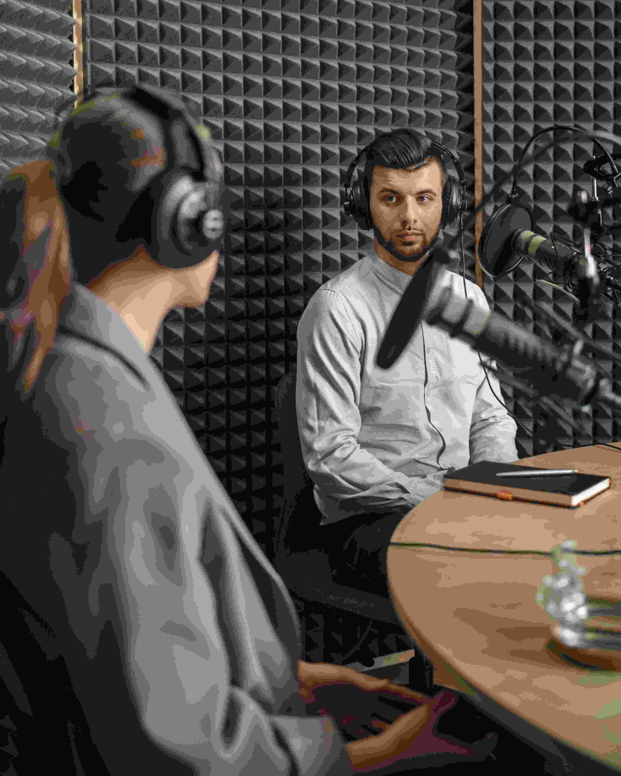 Two people talking in a podcast